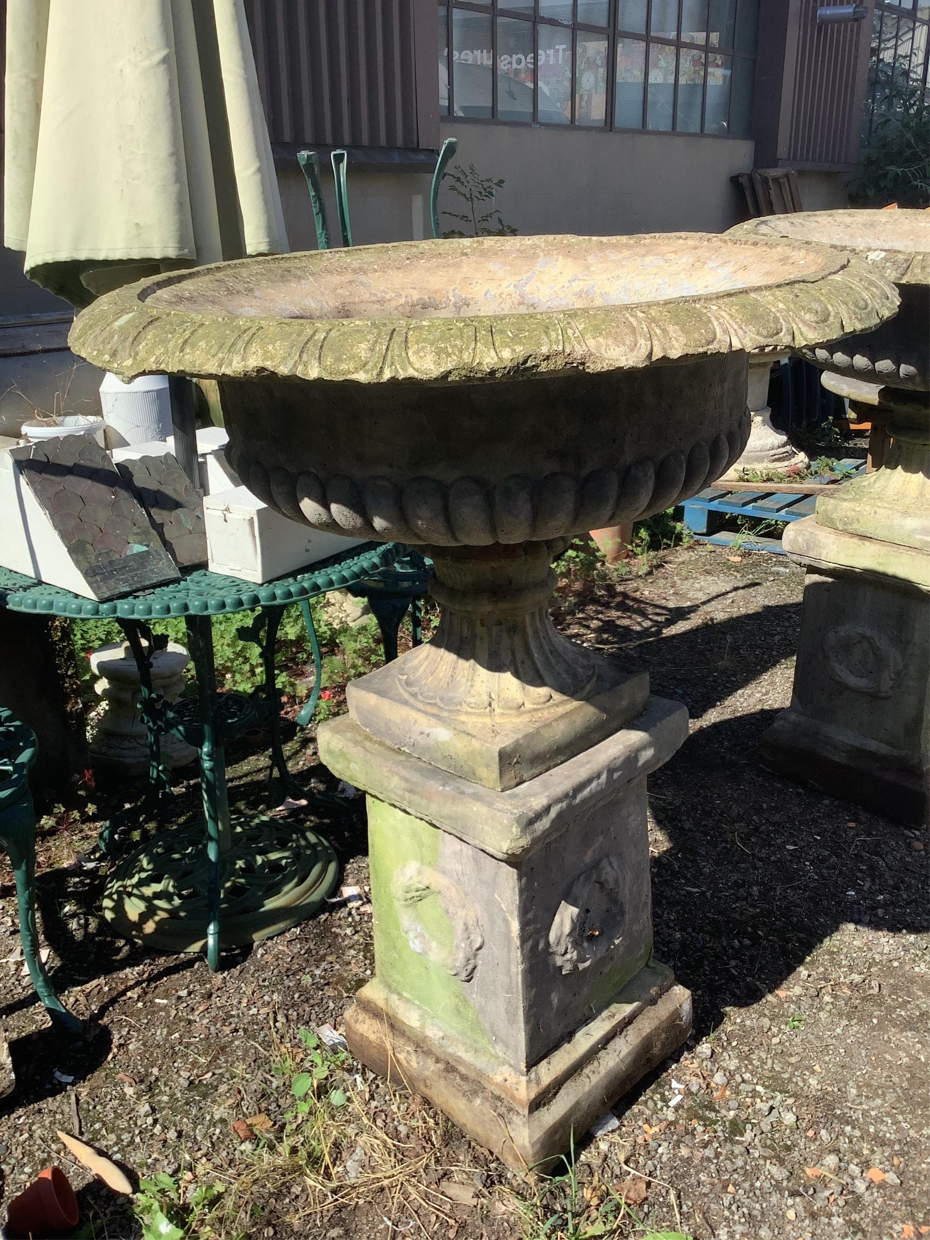 A pair of reconstituted stone campana garden urns on square pedestals, width 94cm, height 116cm. Condition - fair